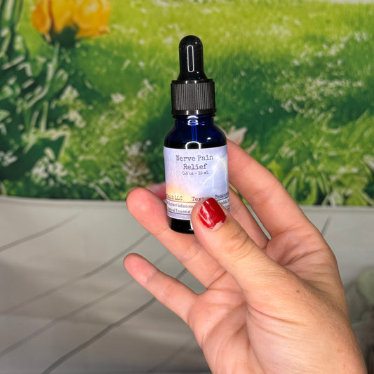 Hand holding a small bottle with a dropper against a green floral background