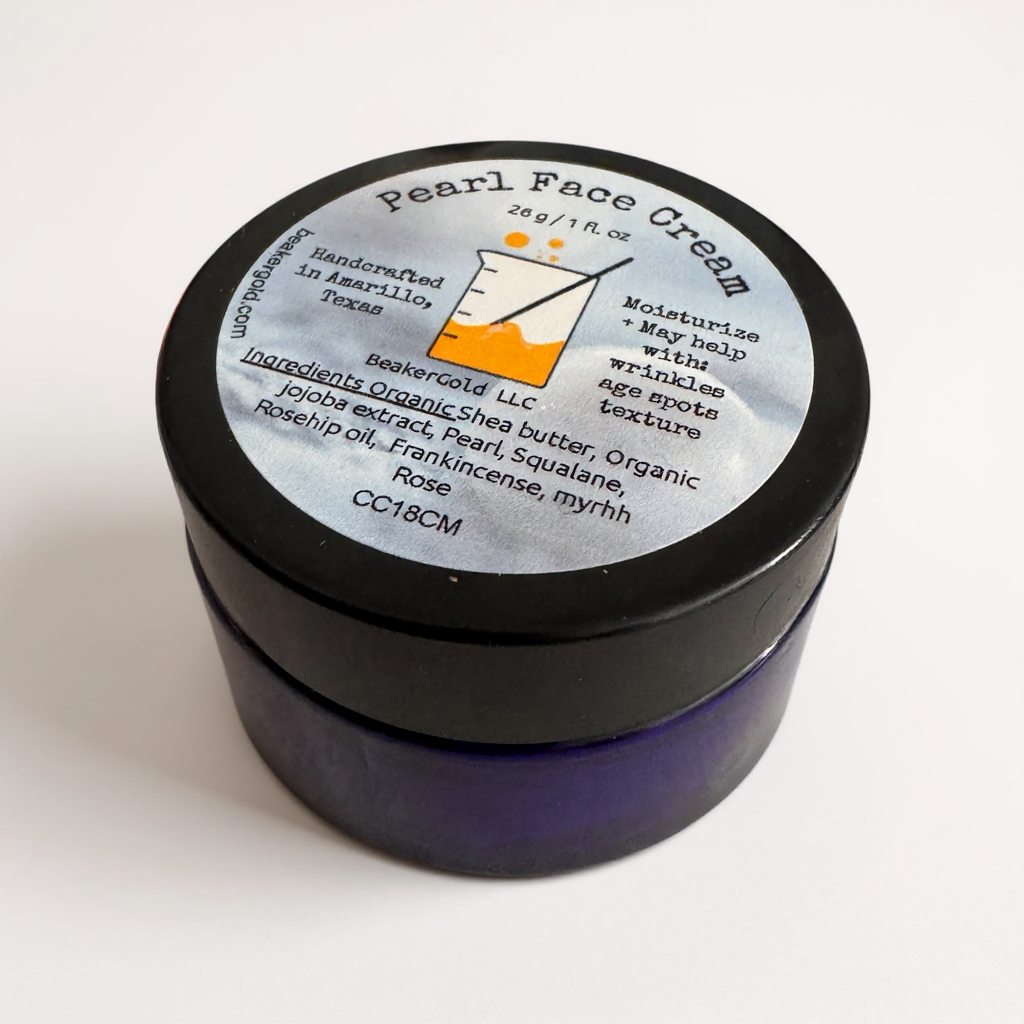 Jar of pearl face cream with a black lid on a white background