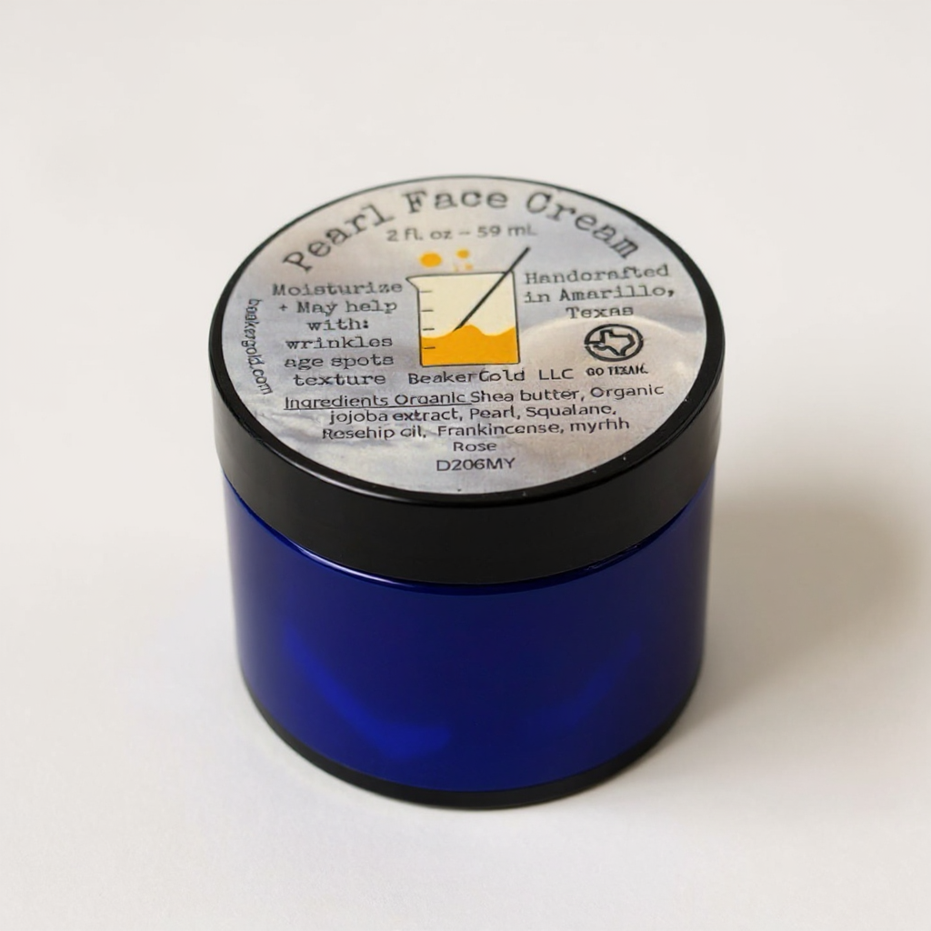 Blue jar of Pearl Face Cream with a black lid on a white background