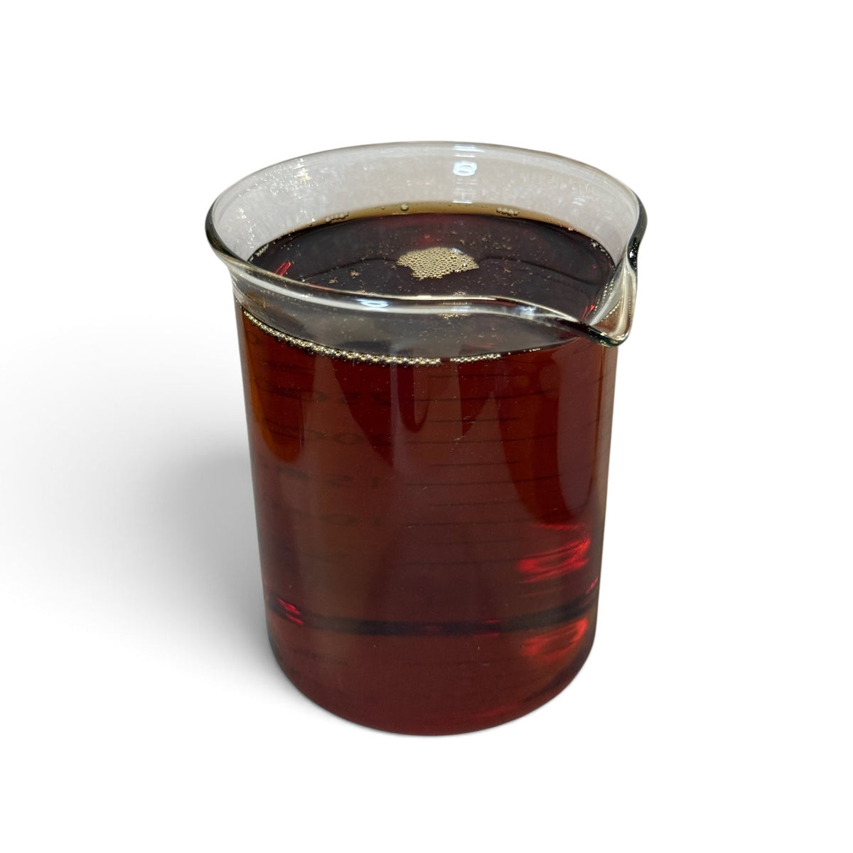 A clear glass beaker filled with a dark reddish-brown liquid, shown on a plain white background.